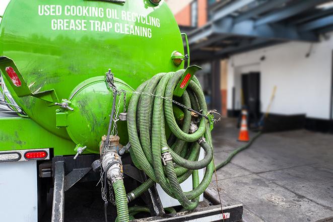 technicians pumping out a commercial grease trap in Three Rivers, MI